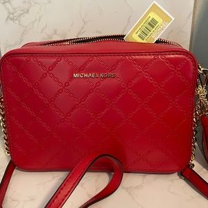 New red Michael Kors crossbody bag.